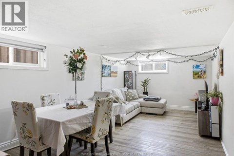 A dining room with a table set for four.