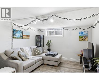 A living room with a grey couch and a small table.