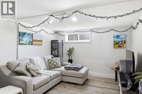 A living room with a grey couch and a small table.