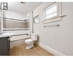 A bathroom with a toilet, sink, and bathtub.