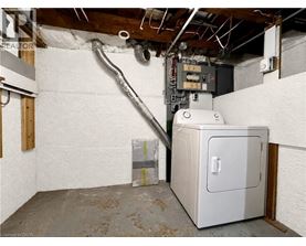 A room with a white wall and a furnace.