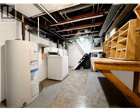 A room with a lot of unfinished work and a refrigerator.