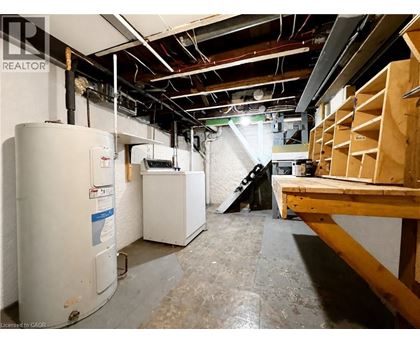 A room with a lot of unfinished work and a refrigerator.