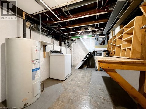 A room with a lot of unfinished work and a refrigerator.