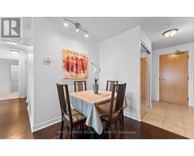 A dining room with a table set for four.