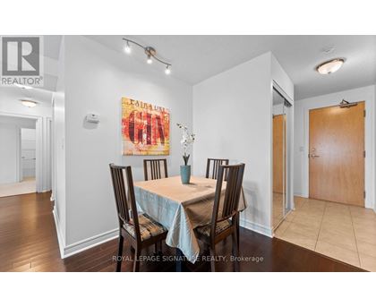 A dining room with a table set for four.