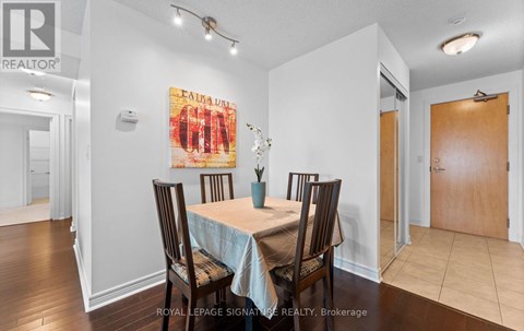 A dining room with a table set for four.