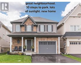 A house with a brick facade and a grey garage door is for sale.