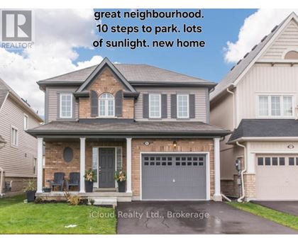 A house with a brick facade and a grey garage door is for sale.