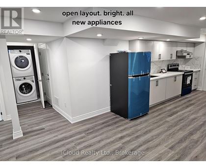 A modern kitchen with a blue fridge and new appliances.