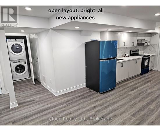 A modern kitchen with a blue fridge and new appliances.