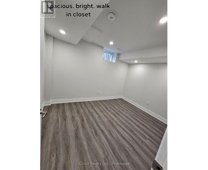 A spacious room with a bright walk in closet.