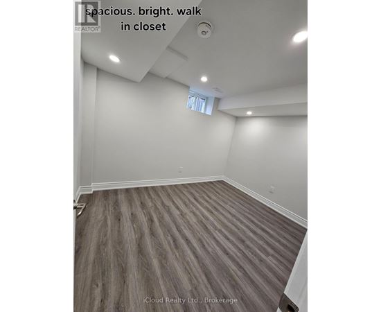 A spacious room with a bright walk in closet.