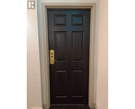 A dark brown door with a gold handle and a number 406 on it.