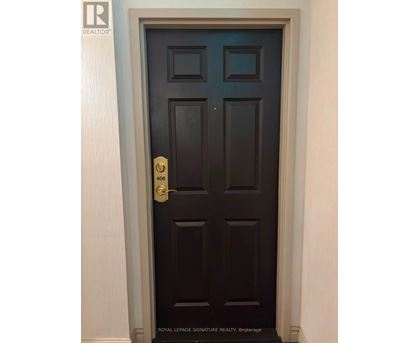 A dark brown door with a gold handle and a number 406 on it.