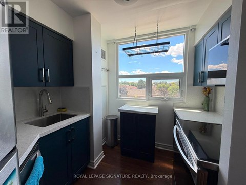 A kitchen with dark blue cabinets and a white countertop.