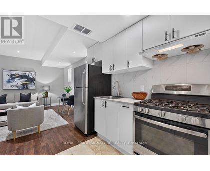 A modern kitchen with a refrigerator, stove, and oven.