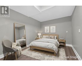 A bedroom with a large bed and a chair.