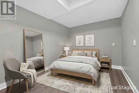 A bedroom with a large bed and a chair.