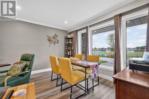 A dining room with a table set for four.