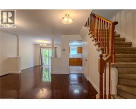 A spacious hallway with a staircase leading to the second floor.