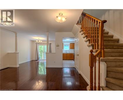A spacious hallway with a staircase leading to the second floor.