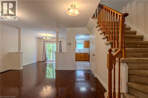 A spacious hallway with a staircase leading to the second floor.