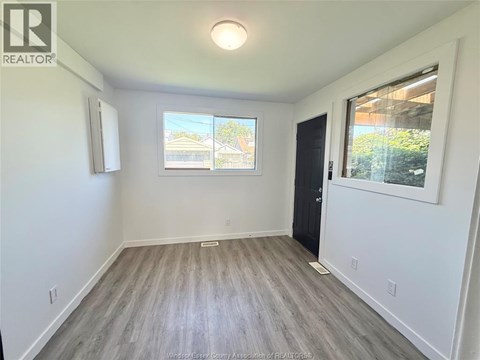 A room with a window and a door is shown.