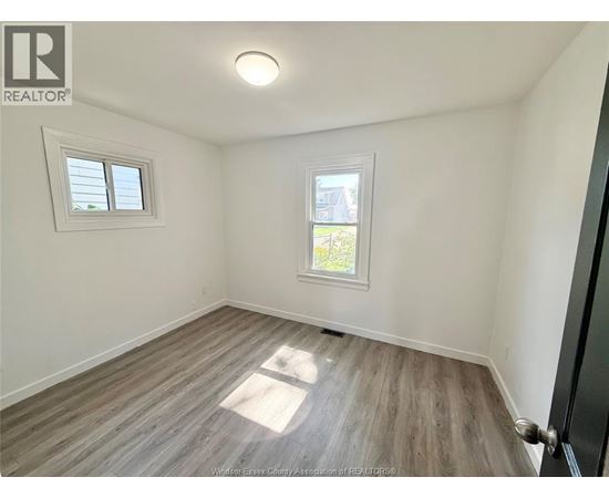 A room with a window and a door.