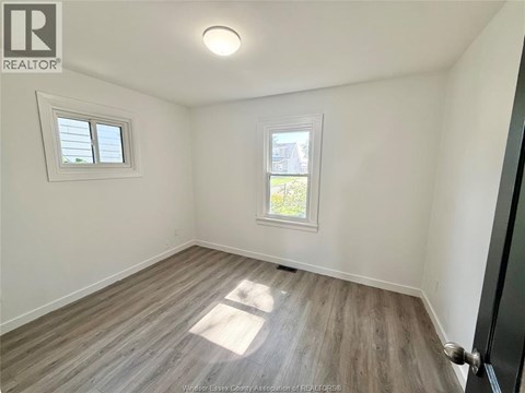 A room with a window and a door.