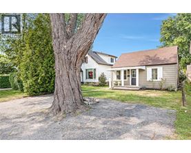 A house with a large tree in front of it.