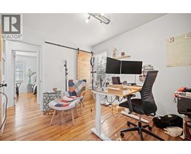 A REALTOR® branded office space with a desk, chair, and computer.