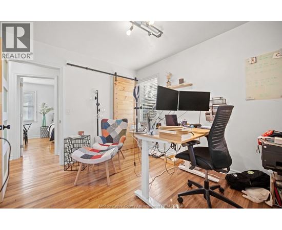 A REALTOR® branded office space with a desk, chair, and computer.