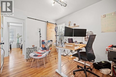 A REALTOR® branded office space with a desk, chair, and computer.