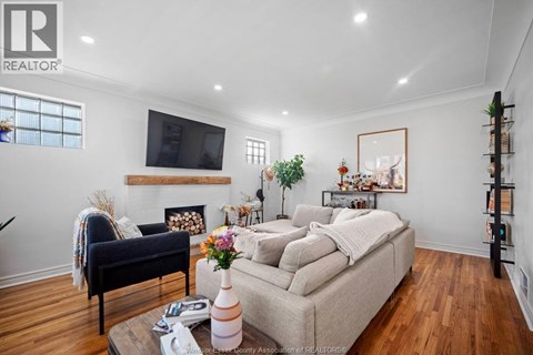A living room with a couch, a chair, a coffee table, and a television.