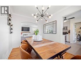 A modern dining room with a wooden table and chairs.