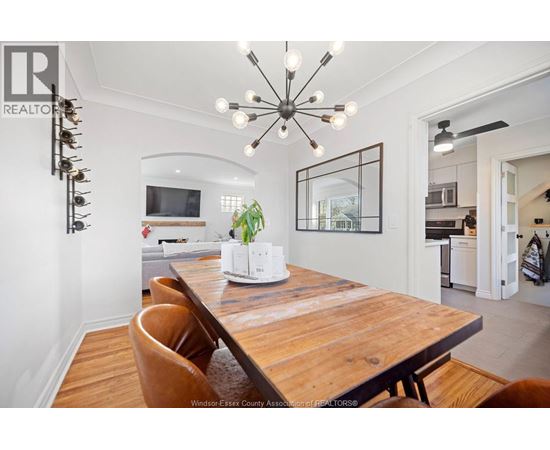 A modern dining room with a wooden table and chairs.