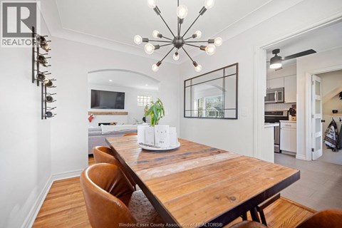 A modern dining room with a wooden table and chairs.