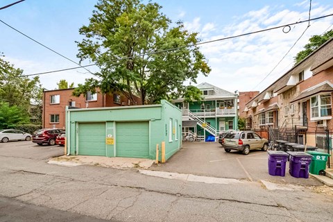 A green garage door is in the middle of a street.