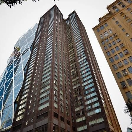 Two tall buildings with many windows are in the foreground.