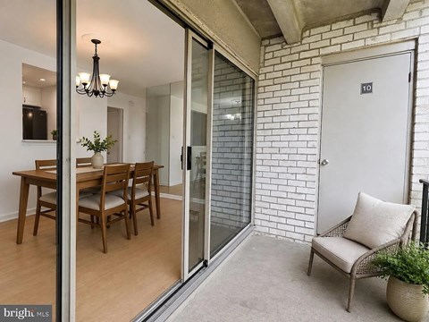 A glass door separates the dining room from the living room.