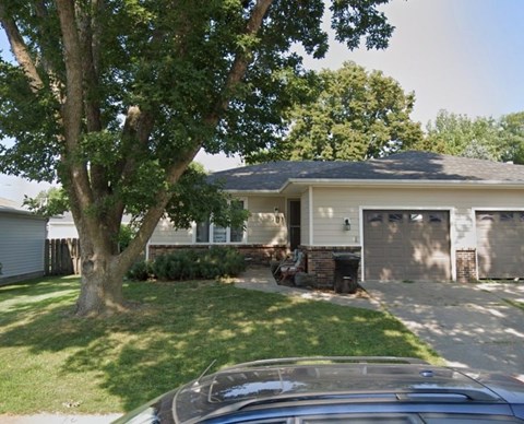 A house with a tree in front of it.