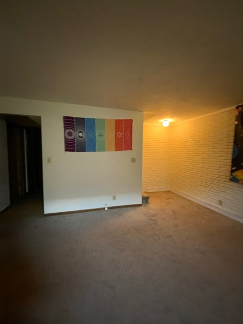 A room with a wall art and a light on.