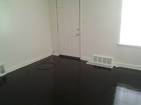 A room with a white door and a window.