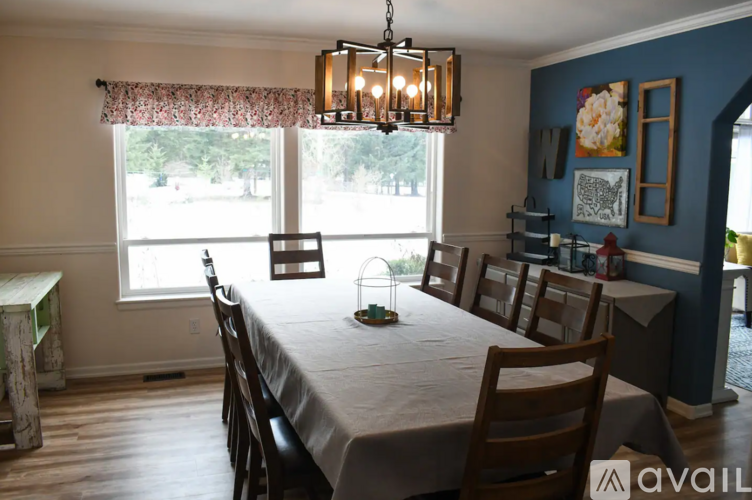 A dining room with a table set for six.