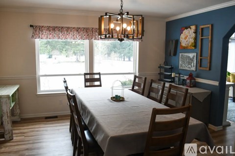 A dining room with a table set for six.