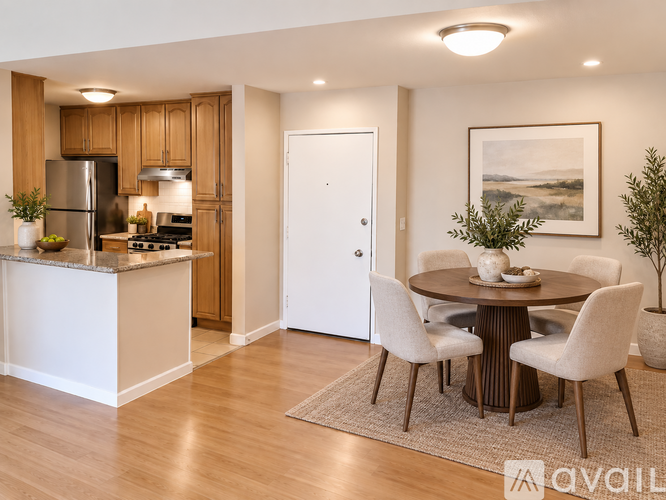 A kitchen with a dining table and chairs.