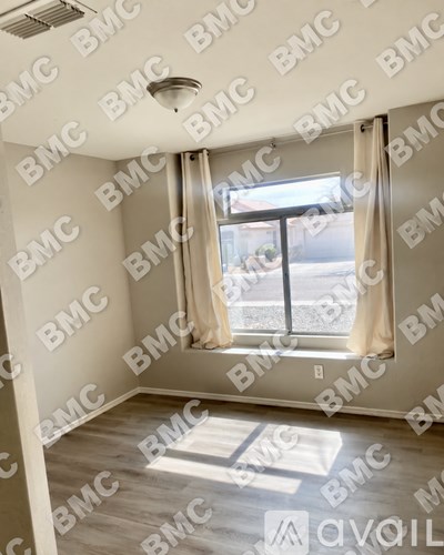 A room with a window and a view of a street.