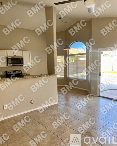 A kitchen area with a microwave and oven built into the cabinetry.