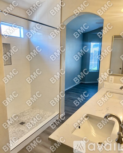 A bathroom with a sink, mirror, and a blue door.